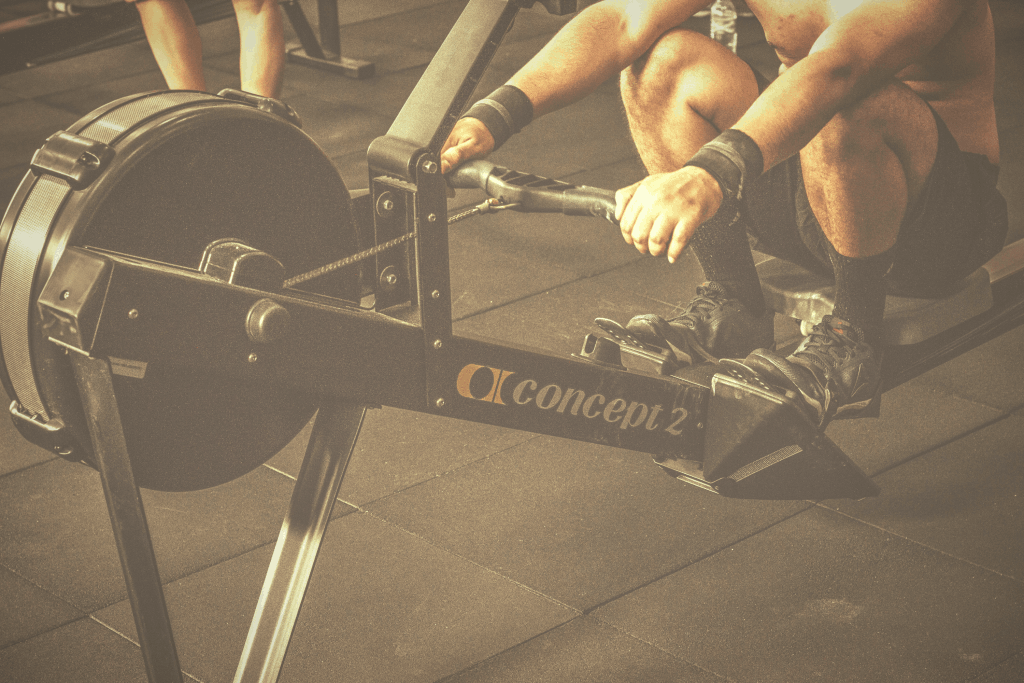 man working out with concept2 model home rowing machine