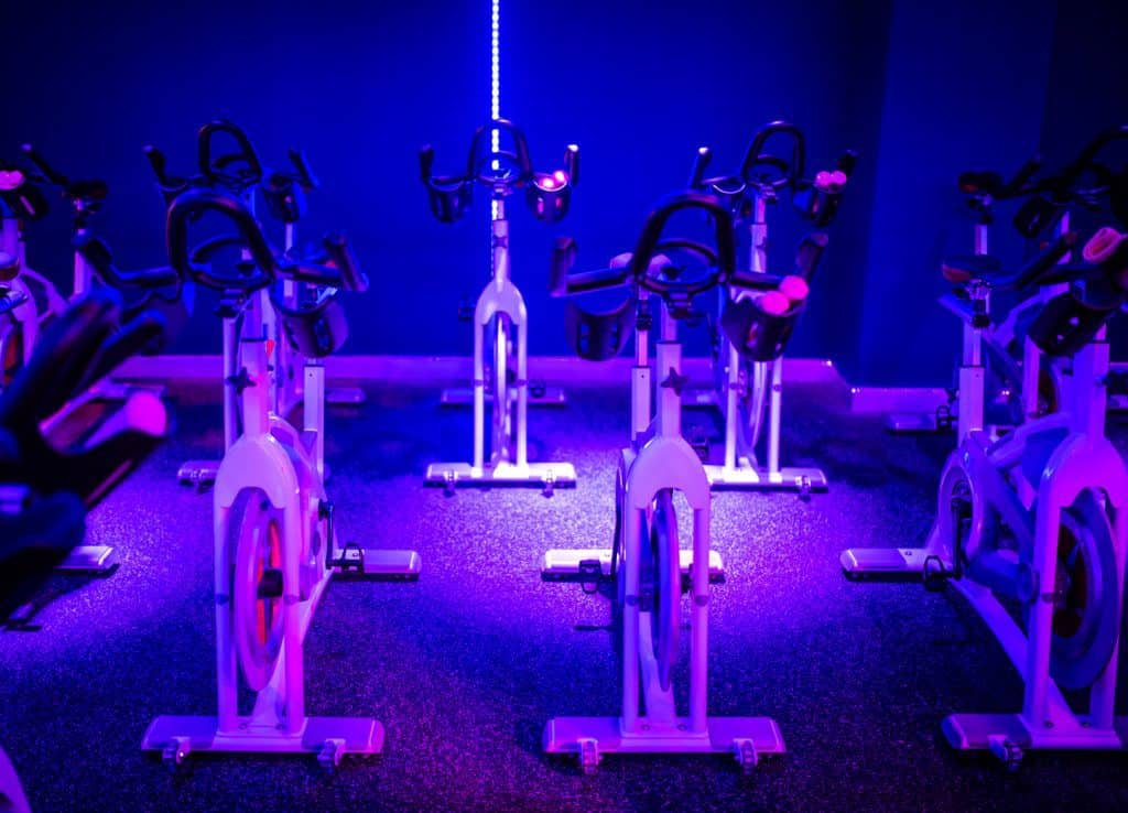My Creative Peloton Alternative - Save A Thousand Bucks An indoor cycling class in a darkened room with purple lights