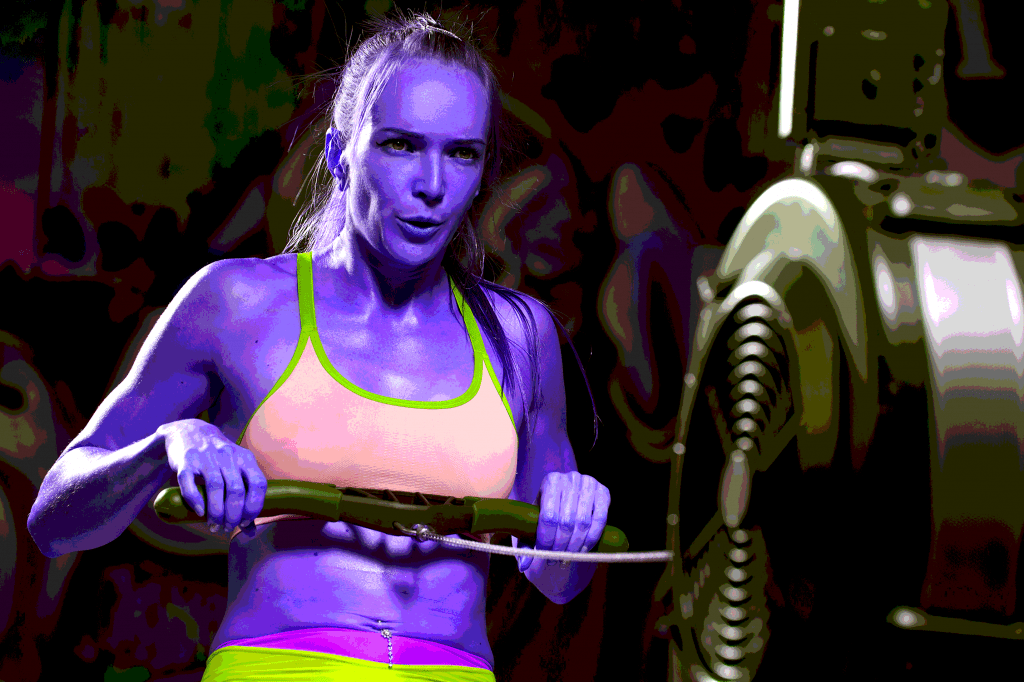 How Long Should A HIIT Workout Be? Woman doing a 15 minute HIIT workout on her home rowing machine - heydayDo image