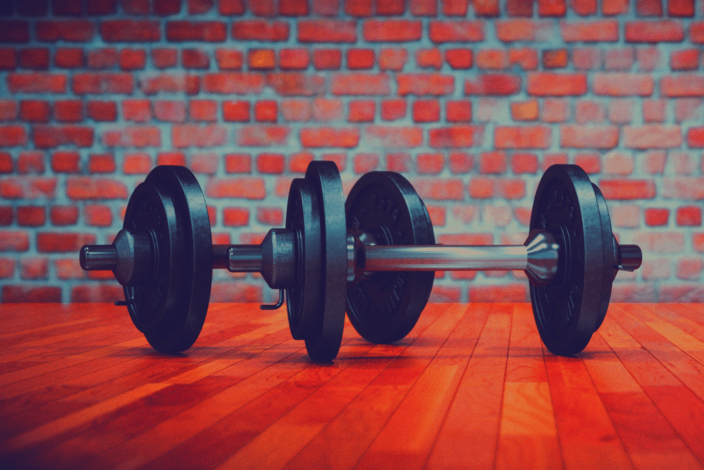 The Great Dumbbell Floor Press: Benefits & How-To Videos Dumbbells on floor ready for floor press exercise