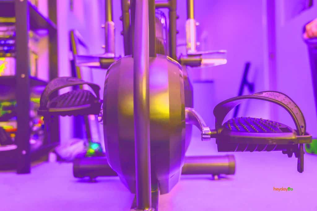 The pedals and front of a folding exercise bike